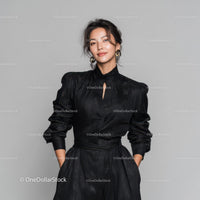 Elegant Woman in Black Dress with Jewelry Standing in Studio