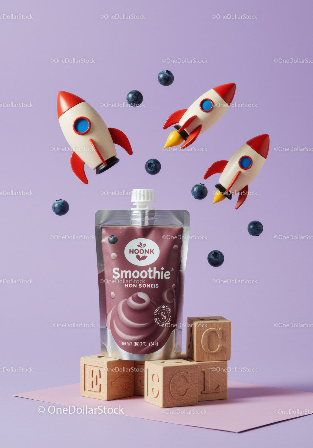 Blueberry smoothie pouch with playful rocket toys and blocks