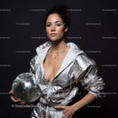 Stylish Woman in Metallic Outfit Holding Disco Ball for Modern Fashion