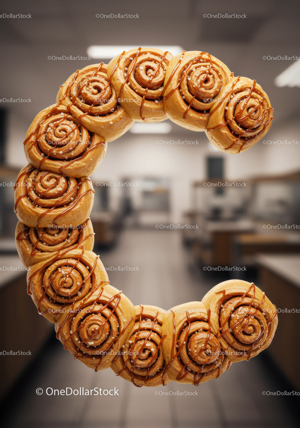 Letter C formed with caramel drizzled cinnamon rolls