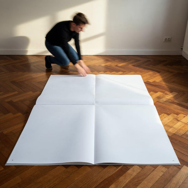Man Unfolding Giant Blank Book on Wooden Floor JPG Mockup Image