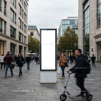 Busy urban street with blank advertising board and pedestrian motion