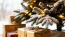 Snow Covered Christmas Gifts Under Illuminated Tree