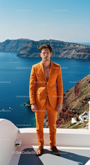 Man in Vibrant Orange Suit Standing by Sea Cliff