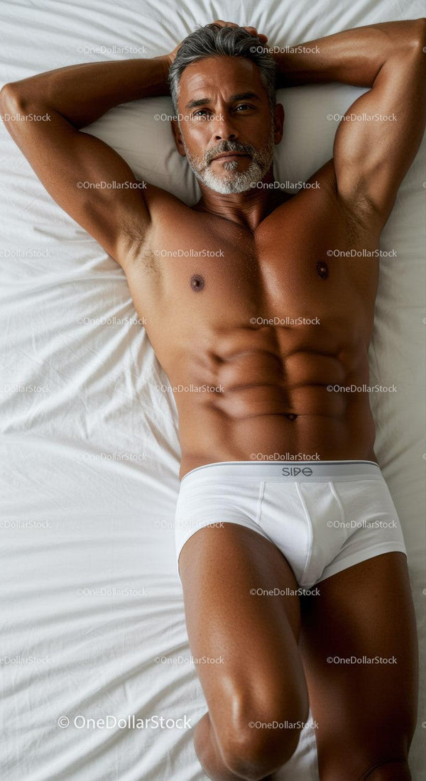 Fit mature man relaxing on bed in white underwear