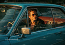Stylish Man Driving Vintage Car in Scenic Sunset