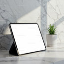 Modern tablet with blank screen on marble countertop