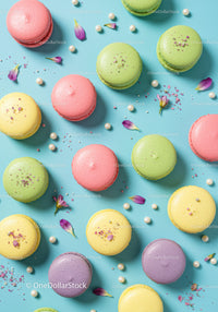 Colorful macarons with flower petals and pearls on blue