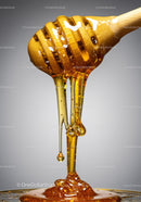 Close up of honey dripping from wooden dipper