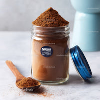 Glass Jar Filled with Fine Ground Coffee and Coffee Beans