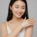 Young Woman Applying Sunscreen for Healthy Glowing Skin