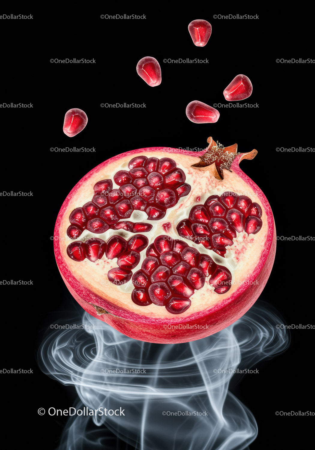 Juicy pomegranate half with scattered seeds and smoke