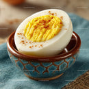 Close-up of a Hard Boiled Egg with Yellow Yolk in a Ceramic Bowl