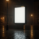 Empty illuminated billboard on rainy city street at night