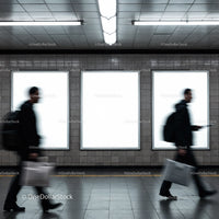 Blurred commuters walking past empty advertising panels