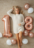 Young woman celebrating 18th birthday with metallic balloons