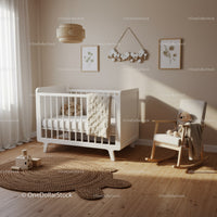 Minimalist nursery with white crib and rocking chair