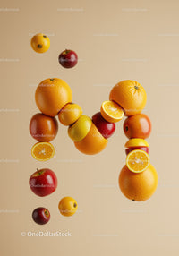Letter M Created from Fresh Citrus and Apples