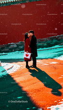 Couple sharing a romantic kiss on snowy winter street