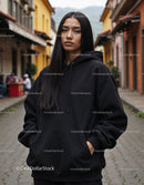 Fashionable Woman Wearing Black Hoodie in Urban City Street