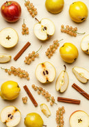 Assorted Fresh Fruits and Cinnamon Sticks on Light Background