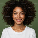 Portrait of a Smiling Woman with Curly Hair Against Green Background