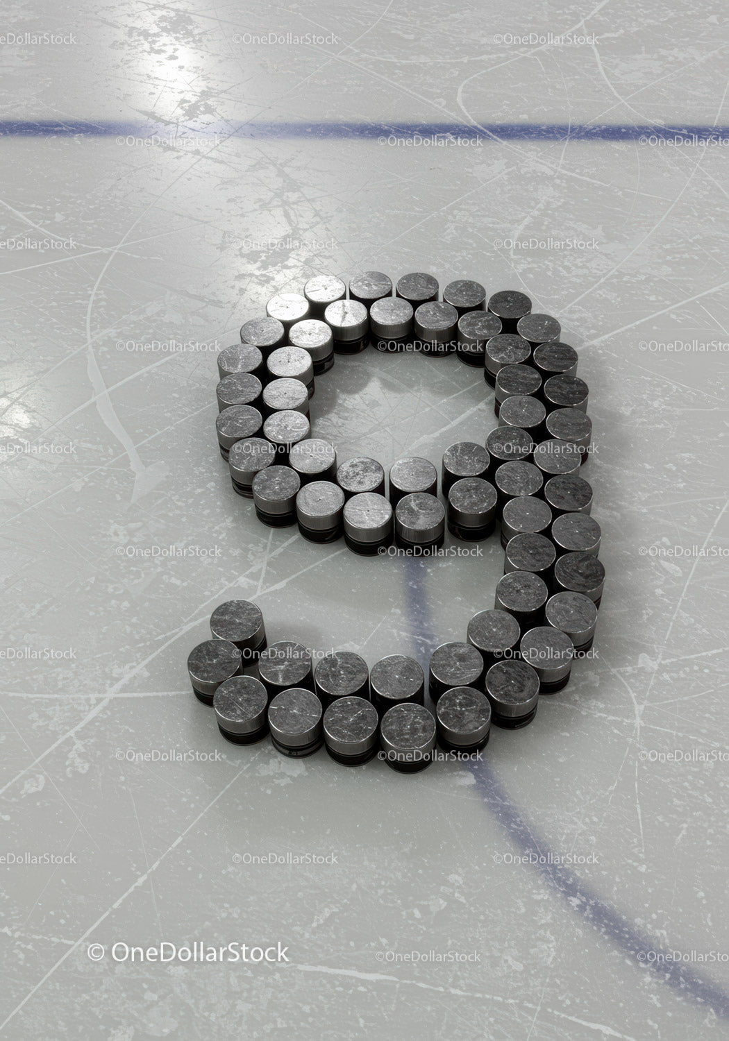 Hockey Pucks Arranged in Number Nine on Ice Rink