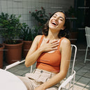 Joyful Woman Laughing in a Bright Outdoor Setting