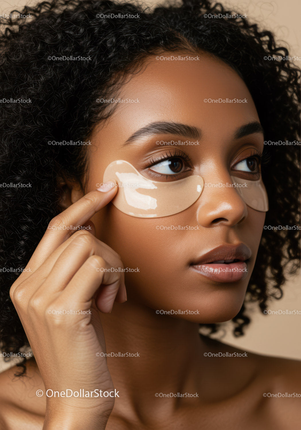Close-up of a woman applying under-eye gel patches in skincare regimen