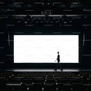 Silhouette of man walking on stage in empty theater
