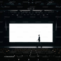 Silhouette of man walking on stage in empty theater