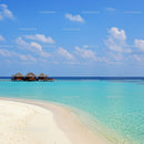 Overwater Bungalows on Turquoise Beach with Clear Blue Sky