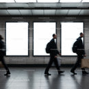 Blurred commuters walking past empty metro billboards