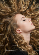 Profile of serene woman with voluminous curly blonde hair