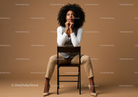 Stylish Confident Woman with Curly Hair in Beige Studio