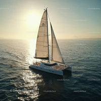 Luxury Sailing Yacht Cruising on Calm Ocean at Sunset