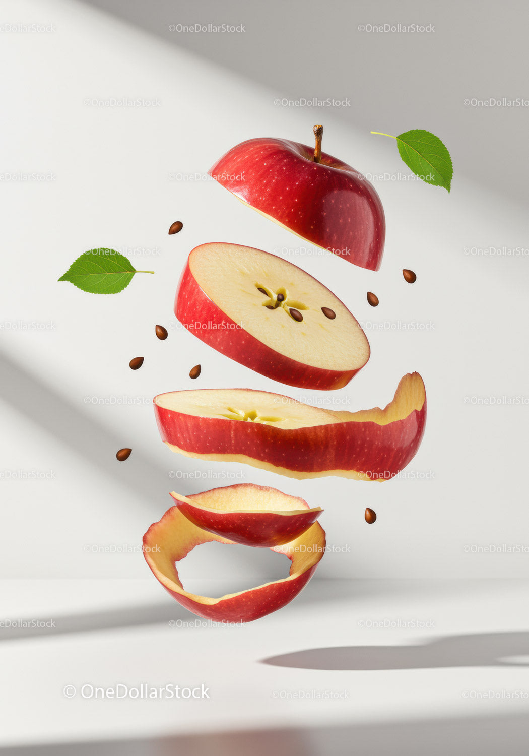Floating Red Apple Slices with Seeds and Green Leaves