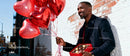 Man Holding Heart Balloons and Chocolates Outdoors