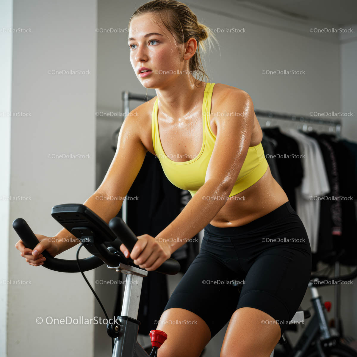 Determined Woman on Exercise Bike in Yellow Sportswear