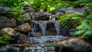 Tranquil Garden Waterfall with Moss-Covered Rocks