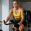 Woman Focused on Intense Indoor Cycling Workout
