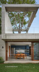 Modern Concrete Structure with Outdoor Dining and Tree Canopy