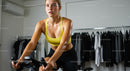 Focused Woman on Exercise Bike in Gym Setting