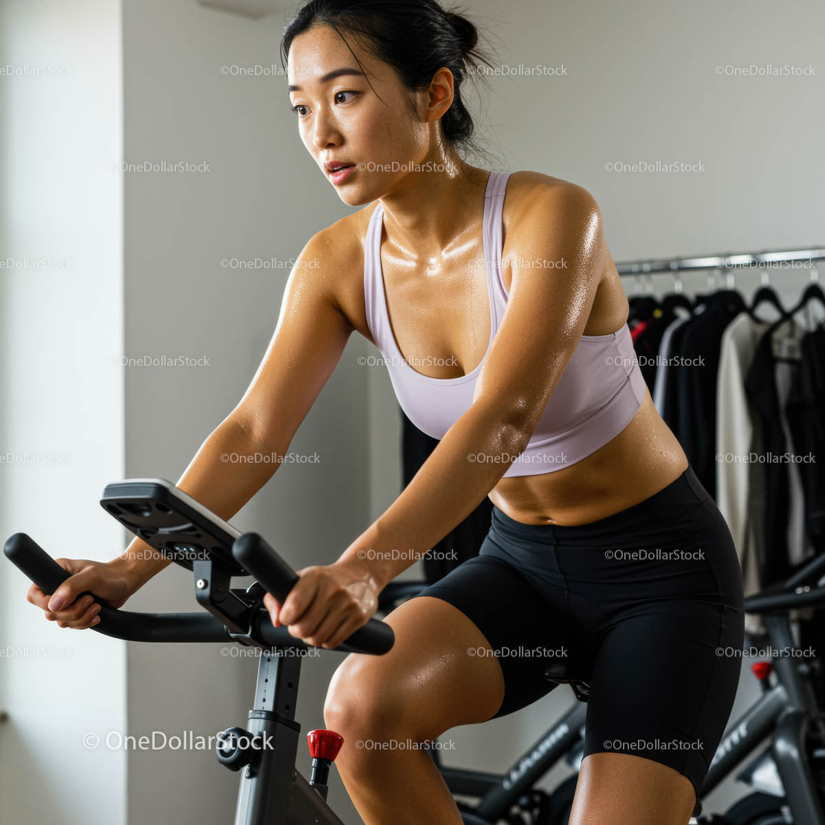 Focused Woman Cycling Indoors in a Modern Gym