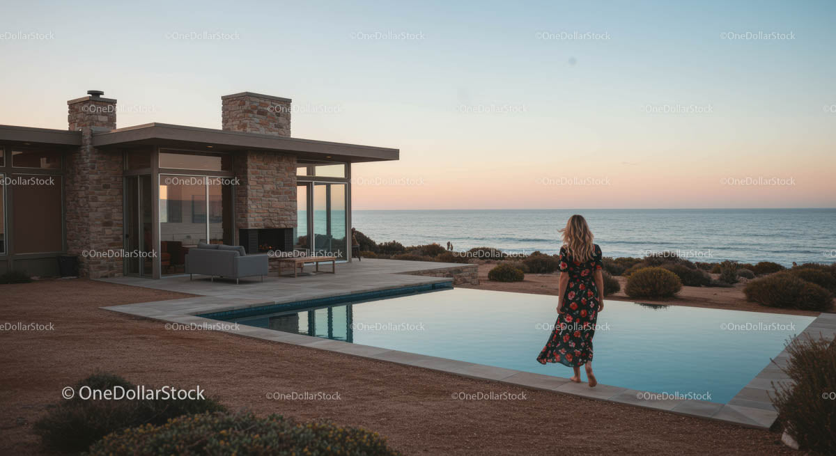 Woman Enjoying Sunset by Modern Coastal Home