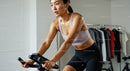 Athletic Woman Engaging in Intense Indoor Cycling Workout