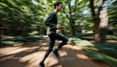 Man Jogging Through a Serene Forest Pathway