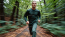Man Running Through Lush Green Forest in Athletic Gear