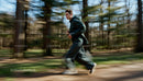 Young Male Jogger Running Through Forest Trail