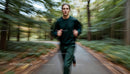 Determined Jogger Running Through a Lush Green Forest